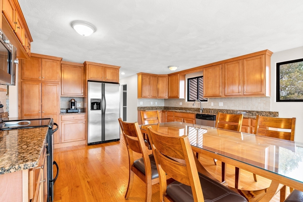 4 Rockland Terrace Saugus, MA 01906 - Photo 5 of 42 a kitchen with stainless steel appliances granite countertop a refrigerator a stove top oven and a view of living room