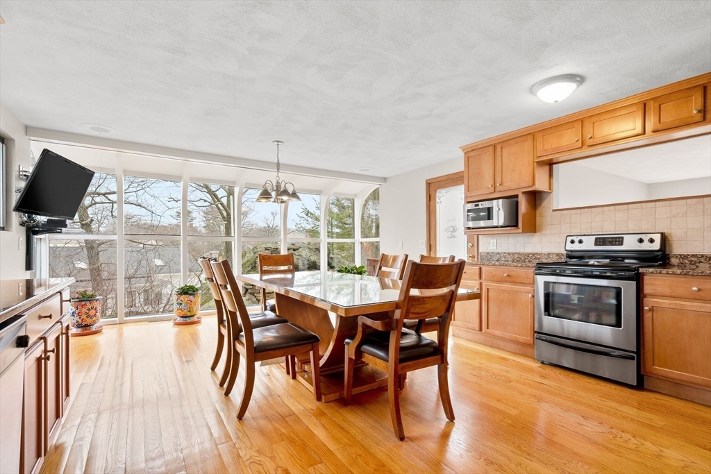 4 Rockland Terrace Saugus, MA 01906 - Photo 8 of 42 a dining room with stainless steel appliances a table and chairs