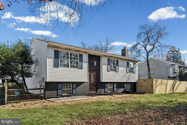 a house that has a tree in front of it