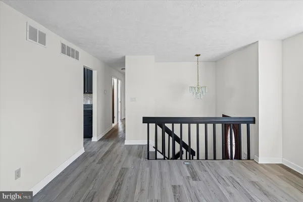 a view of hallway with wooden floor
