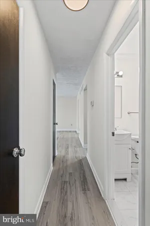 a view of a room with wooden floor