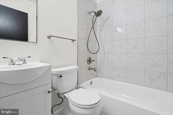 a bathroom with a toilet a sink and a bathtub