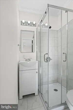 a bathroom with a shower a sink and mirror