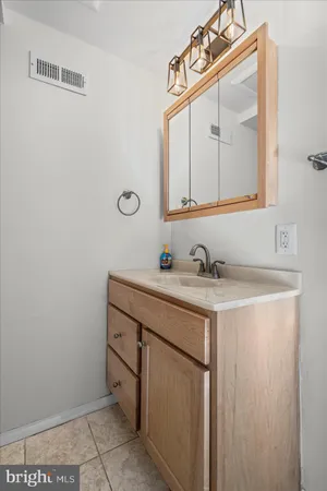 a bathroom with a granite countertop sink a mirror and a vanity