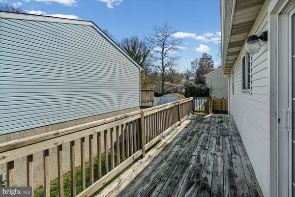 a view of a balcony with wooden floor and potted plants