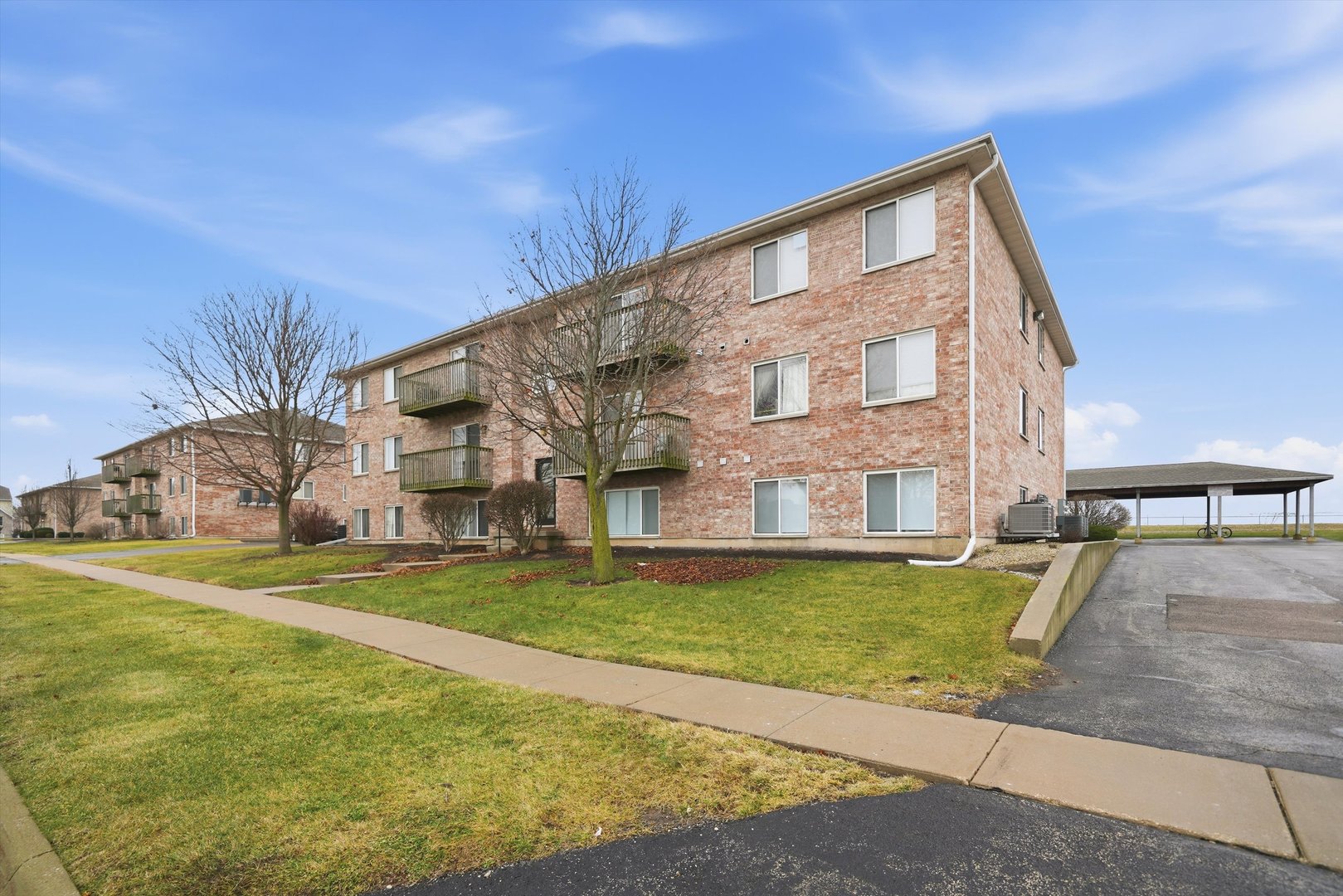 575 North Strack Street, Unit 302 Cortland, IL 60112 - Photo 11 of 11 a view of swimming pool with outdoor seating and house in the background