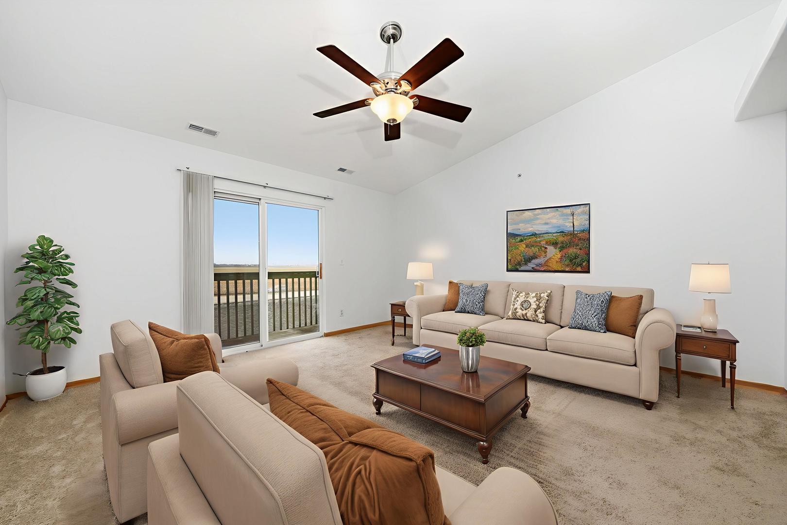 575 North Strack Street, Unit 302 Cortland, IL 60112 - Photo 3 of 11 a living room with furniture ceiling fan and a large window