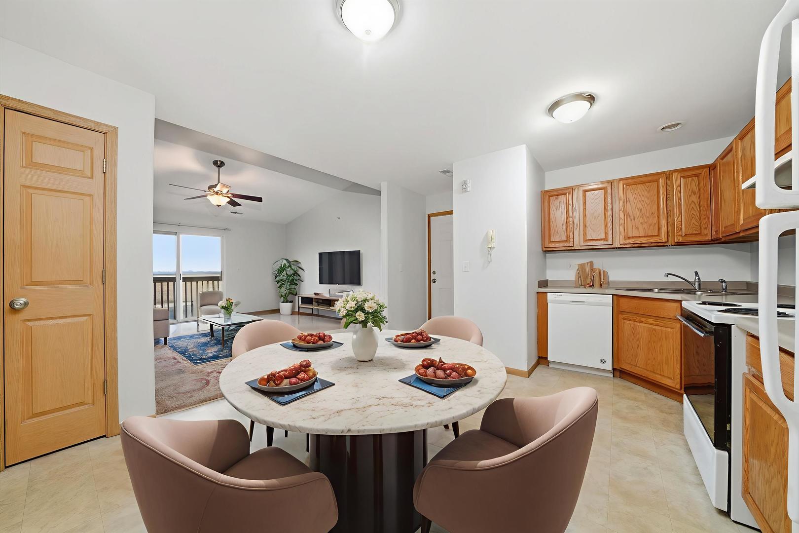 575 North Strack Street, Unit 302 Cortland, IL 60112 - Photo 6 of 11 a view of a dining room with furniture and a kitchen
