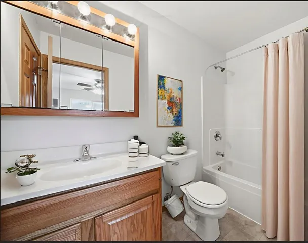 a spacious bedroom with a bed and a flat screen tv