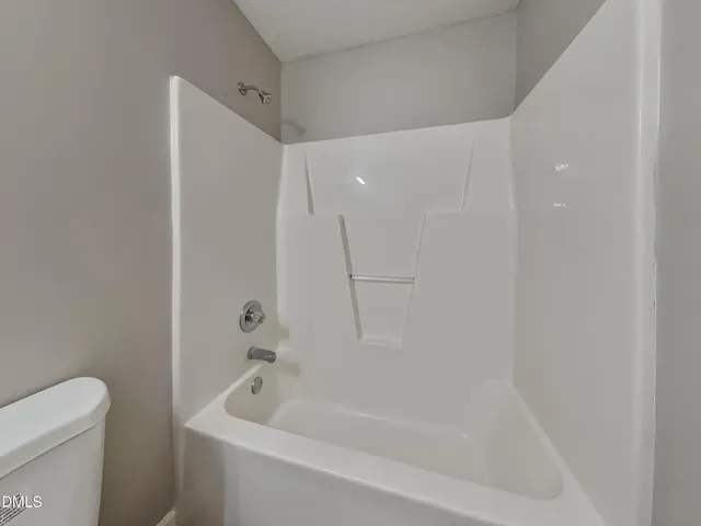a bathroom with a bathtub and a toilet