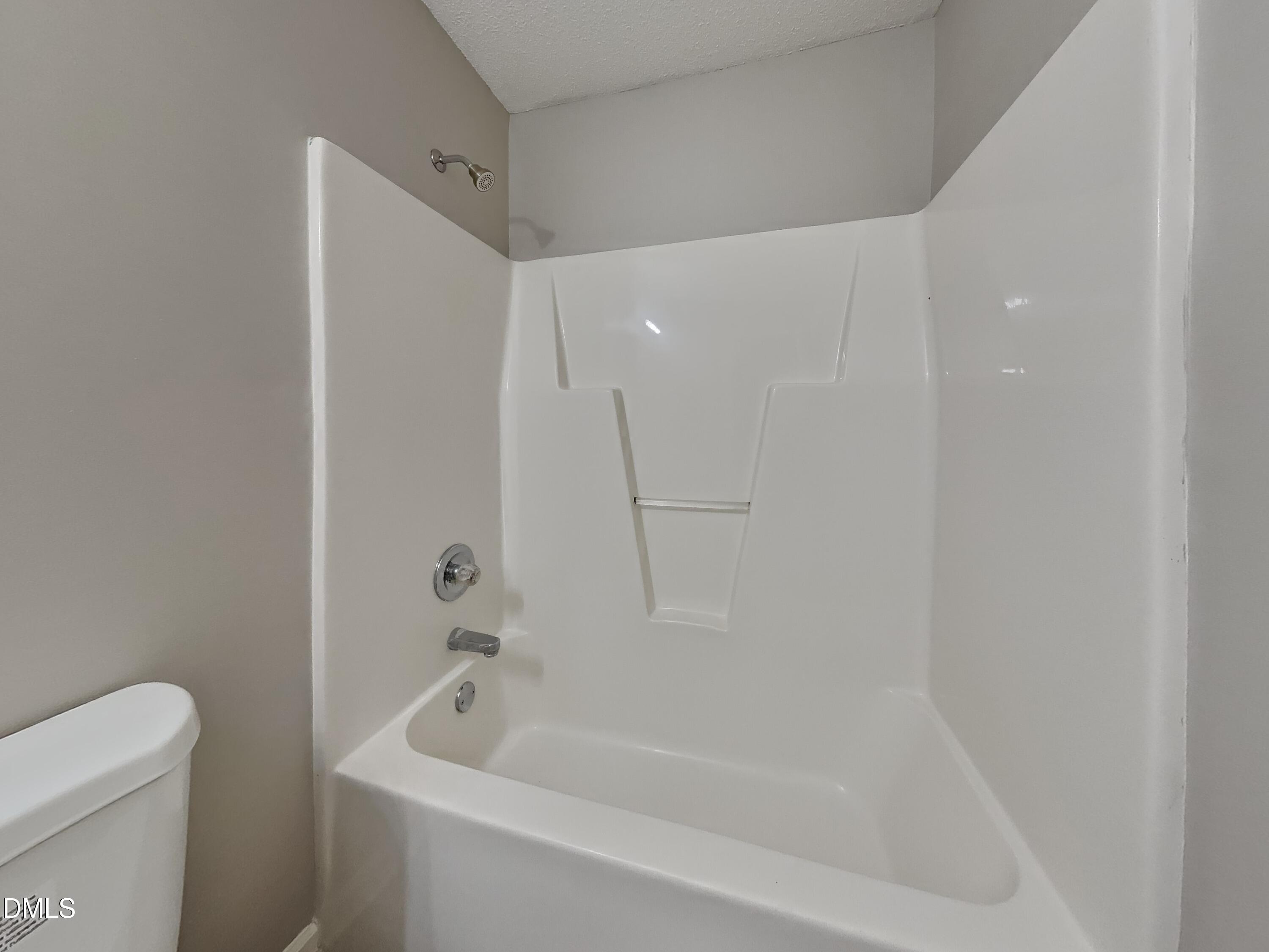 2028 Ballston Place Knightdale, NC 27545 - Photo 14 of 15 a bathroom with a bathtub and a toilet
