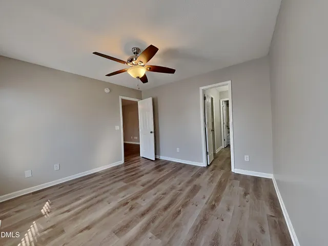 a view of an empty room with wooden floor