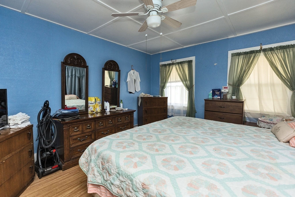 15 Main Street Allenstown, NH 03275 - Photo 17 of 39 a bedroom with a bed and a dresser with mirror