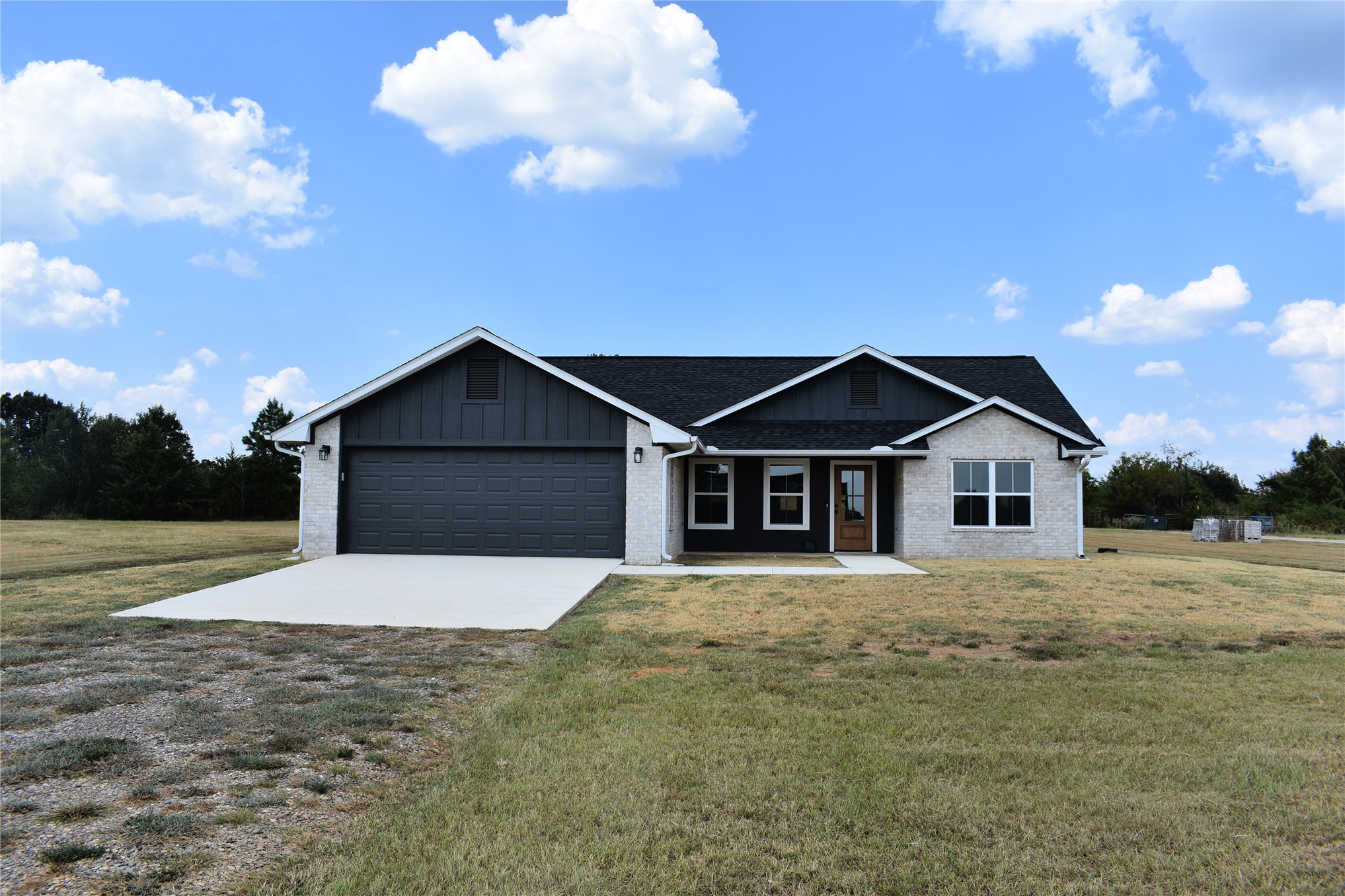 2915 East 2090 Road, Unit LOT 1 Hugo, OK 74743 - Photo 23 of 28 Single-story residence featuring light-colored brick and dark siding accents