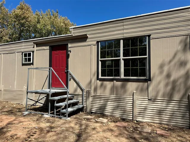 a view of wooden house with large windows