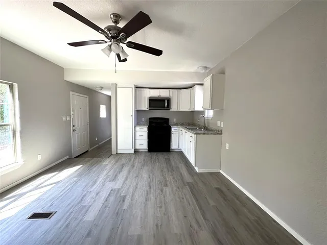a view of a kitchen with a sink dishwasher and a microwave