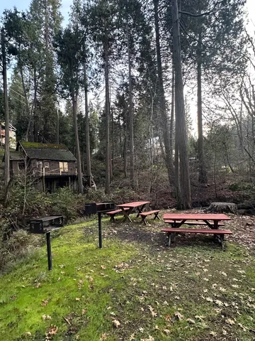 a view of swimming pool with chairs and wooden fence