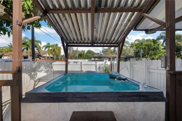 a backyard of a house with barbeque oven and outdoor seating