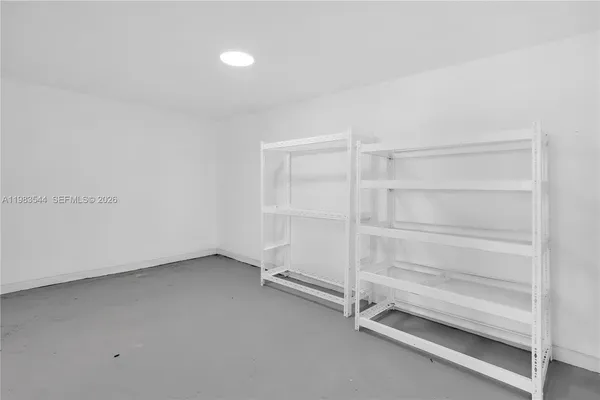 a white house that has a tree in front of a house