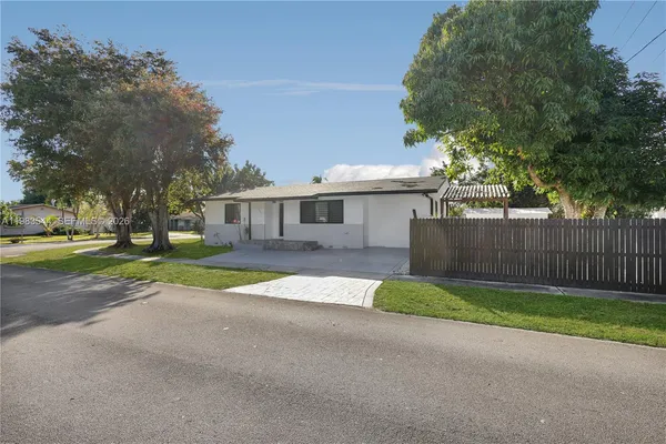 an aerial view of a house with a yard basket ball court and outdoor seating