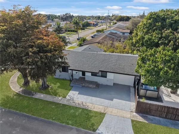 an aerial view of a house with a yard