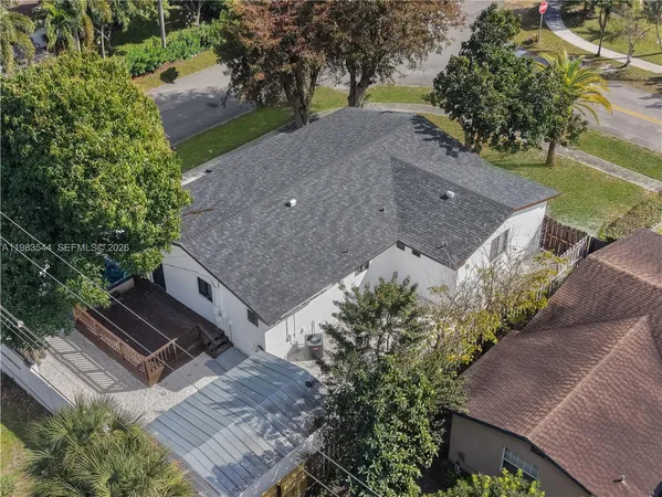 an aerial view of a house with a yard