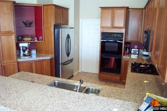 1815 Caughlin Creek Road Reno, NV 89519 - Photo 2 of 9 a kitchen with stainless steel appliances granite countertop a refrigerator and a sink