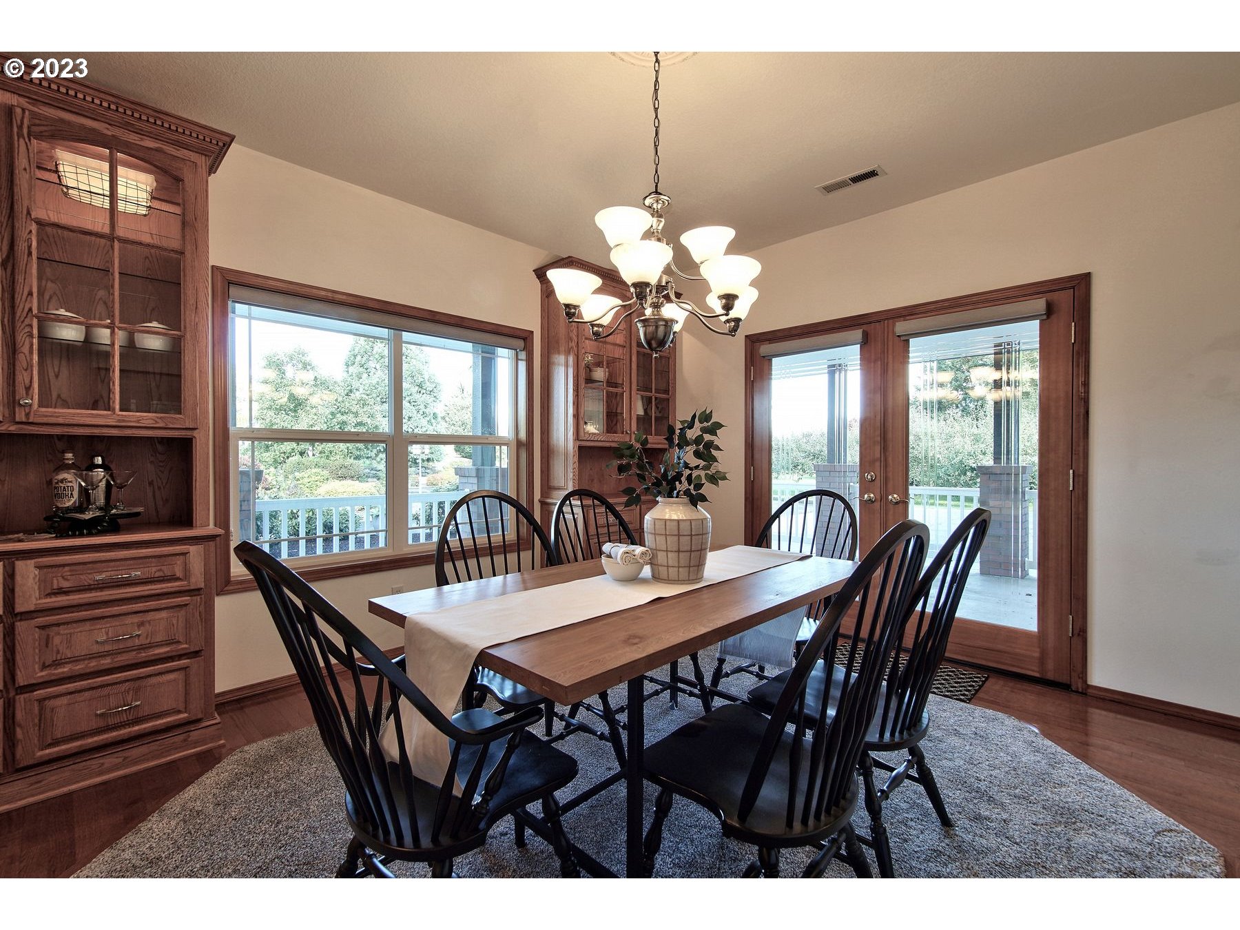 1101 Northeast 264th Street Ridgefield, WA 98642 - Photo 14 of 48 a dining room with furniture a large window and a chandelier