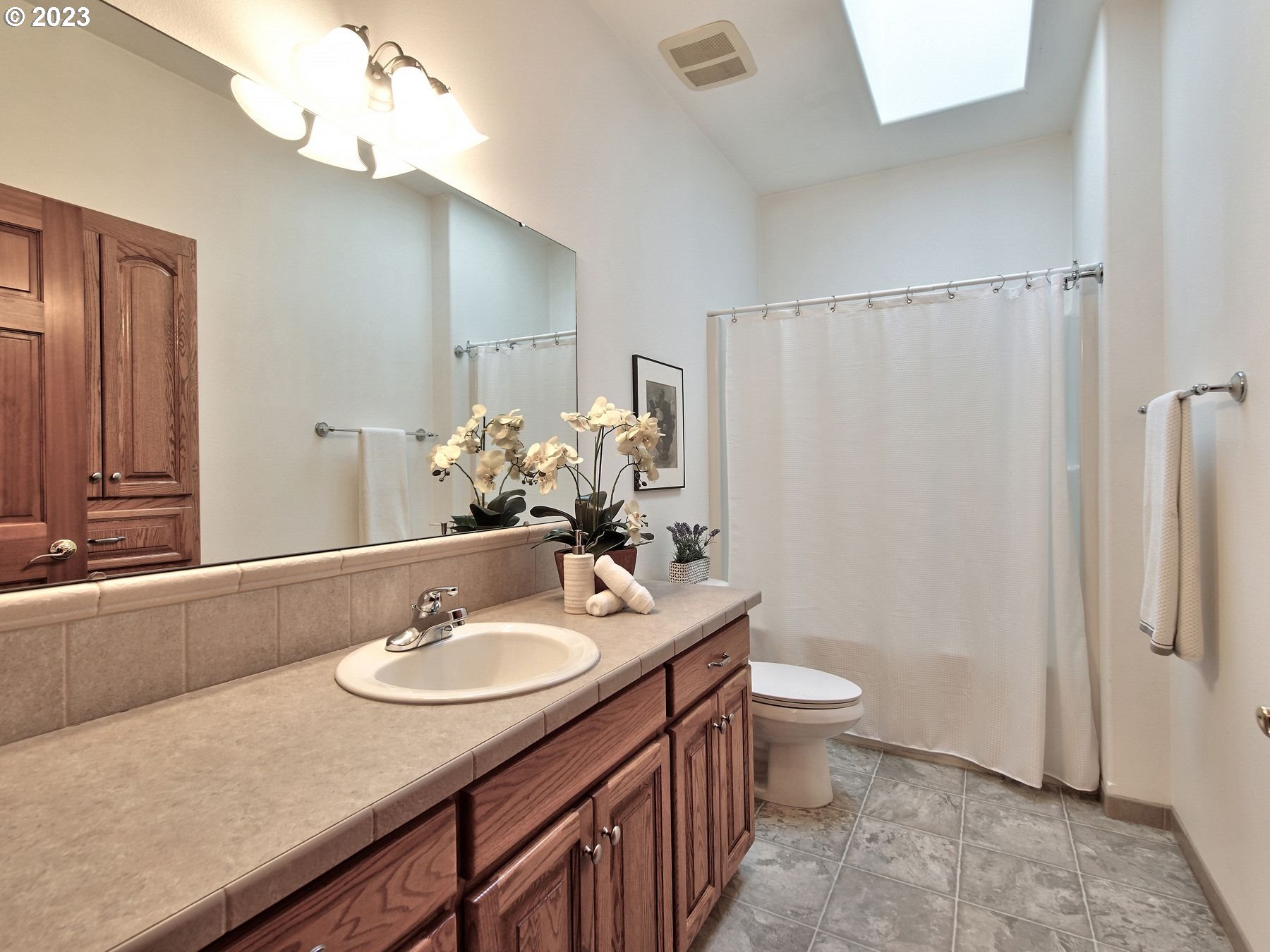 1101 Northeast 264th Street Ridgefield, WA 98642 - Photo 20 of 48 a bathroom with a sink a toilet a mirror and shower