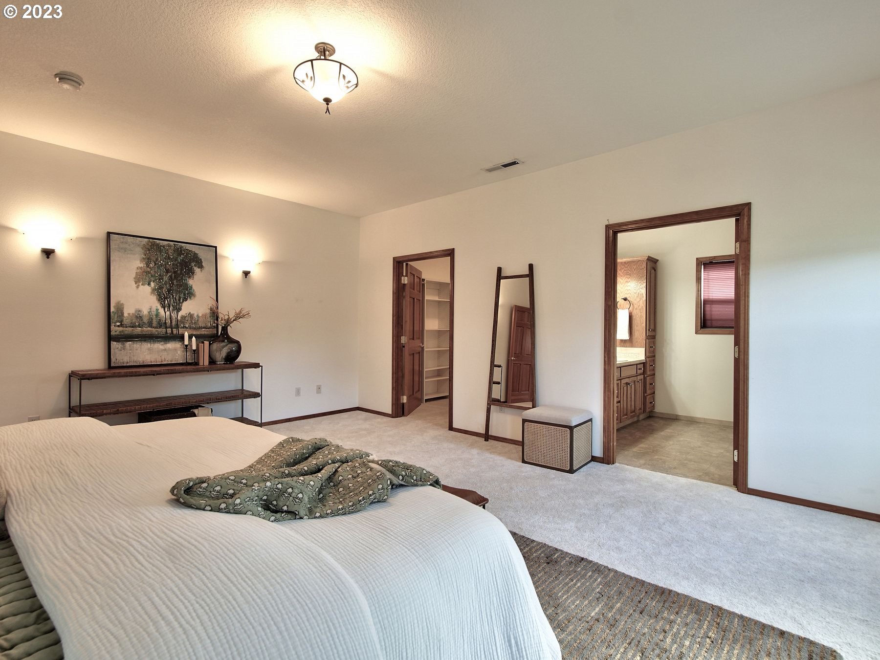 1101 Northeast 264th Street Ridgefield, WA 98642 - Photo 22 of 48 a bedroom with a bed and a chandelier