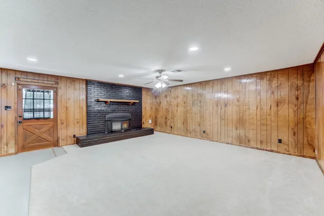 a view of an empty room with a fireplace