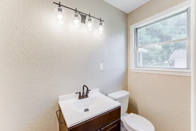 a white toilet sitting next to a bathroom sink