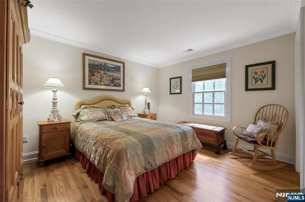 22 Meadowlake Drive Mahwah, NJ 07430 - Photo 23 of 39 a bedroom with a bed and wooden floor