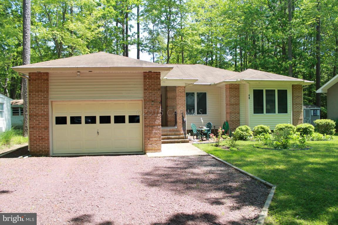49 Moonraker Road Ocean Pines, MD 21811 - Photo 1 of 27 a front view of a house with yard and green space