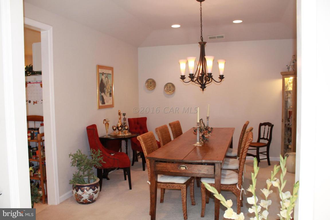49 Moonraker Road Ocean Pines, MD 21811 - Photo 11 of 27 a view of a dining room with furniture and chandelier