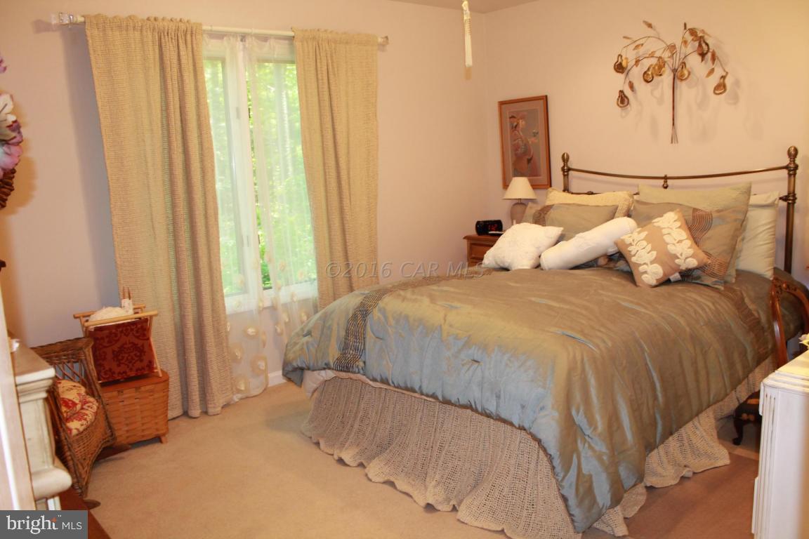 49 Moonraker Road Ocean Pines, MD 21811 - Photo 14 of 27 a bedroom with a bed and a painting on the wall