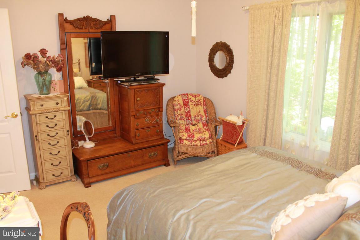 49 Moonraker Road Ocean Pines, MD 21811 - Photo 15 of 27 a bedroom with furniture and a flat screen tv