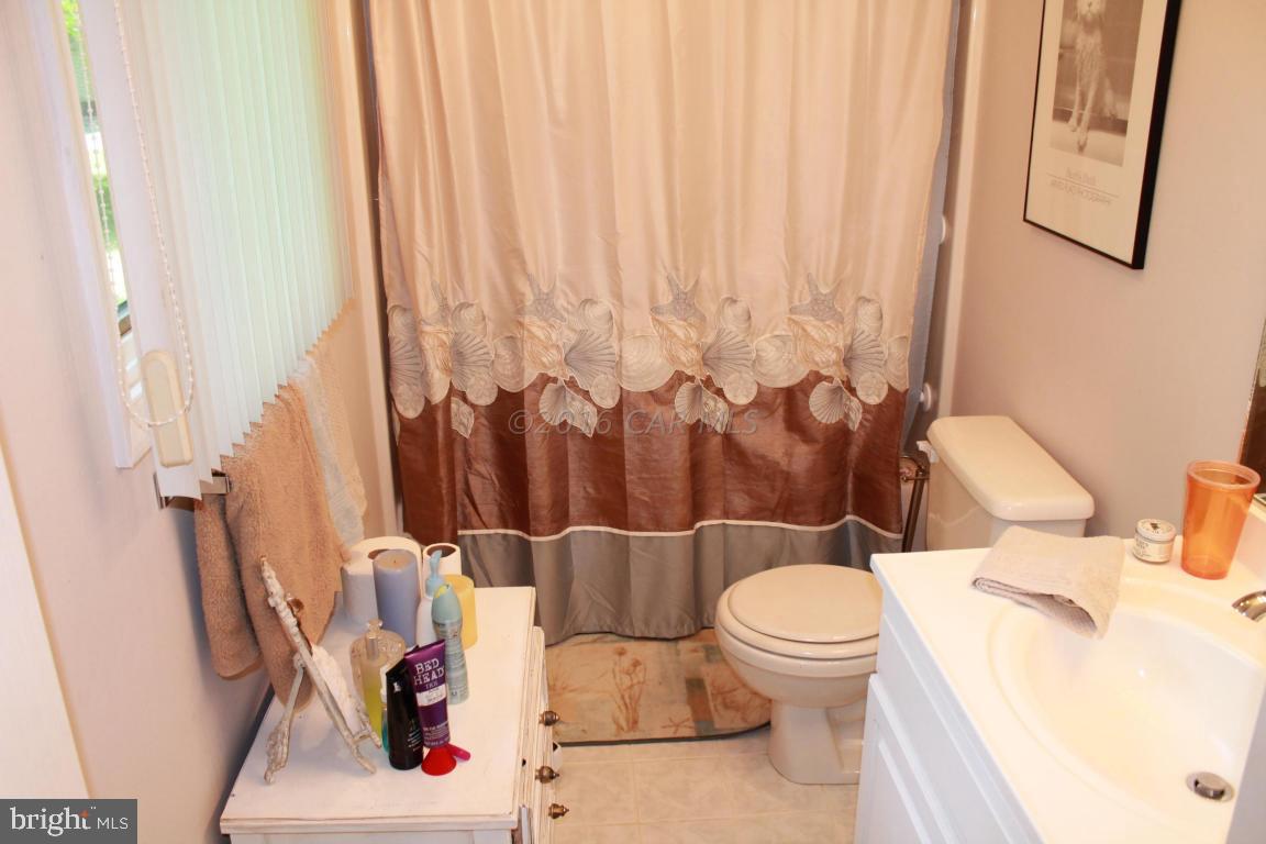 49 Moonraker Road Ocean Pines, MD 21811 - Photo 16 of 27 a white toilet sitting next to a bathroom sink