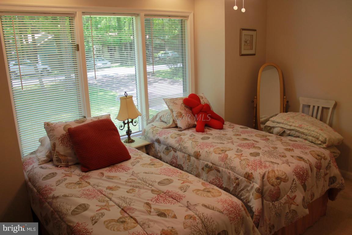 49 Moonraker Road Ocean Pines, MD 21811 - Photo 17 of 27 a bed sitting in a bedroom next to a window