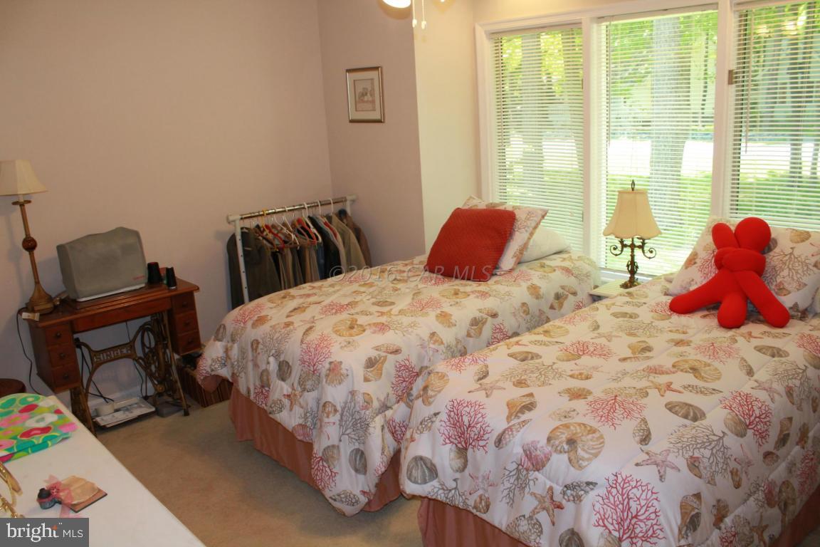 49 Moonraker Road Ocean Pines, MD 21811 - Photo 19 of 27 a bedroom with a bed and wooden floor