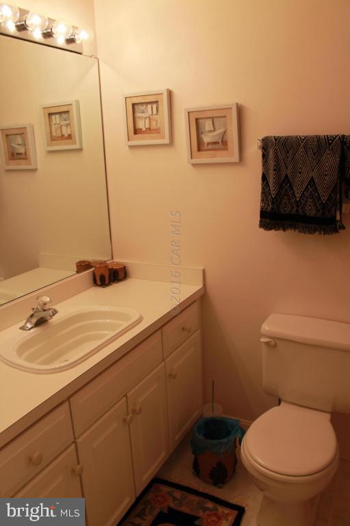 49 Moonraker Road Ocean Pines, MD 21811 - Photo 20 of 27 a bathroom with a toilet a sink and mirror