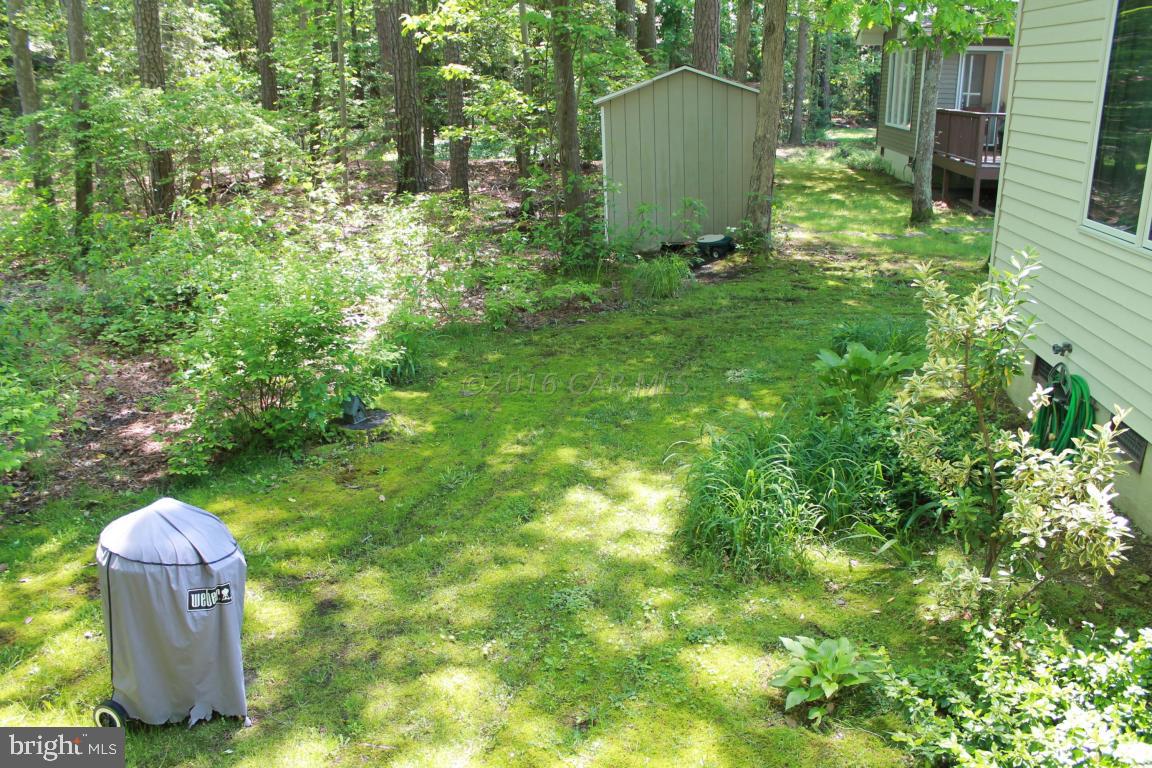 49 Moonraker Road Ocean Pines, MD 21811 - Photo 26 of 27 a backyard of a house with table and chairs