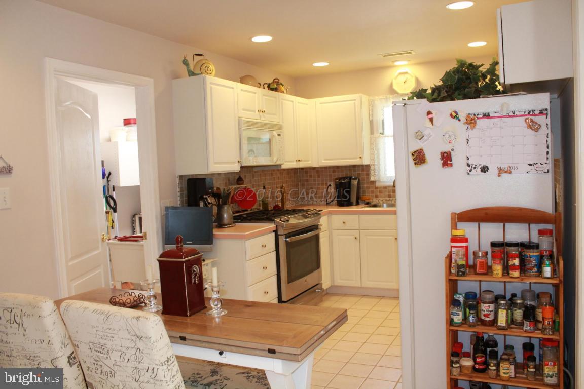 49 Moonraker Road Ocean Pines, MD 21811 - Photo 6 of 27 a kitchen with stainless steel appliances granite countertop a refrigerator and a stove