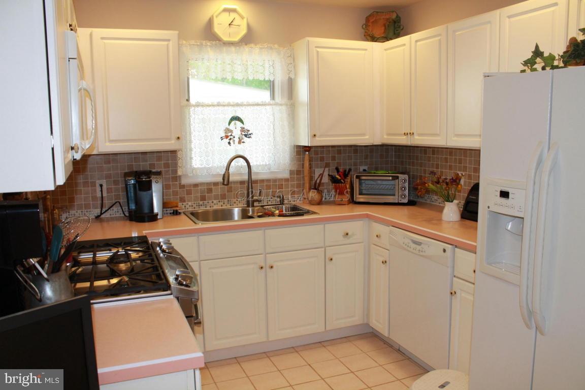 49 Moonraker Road Ocean Pines, MD 21811 - Photo 7 of 27 a kitchen with white cabinets and appliances