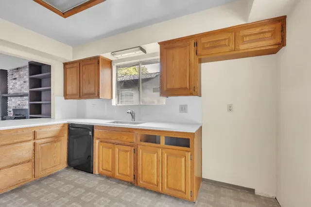 a large white kitchen with a sink a washer and dryer