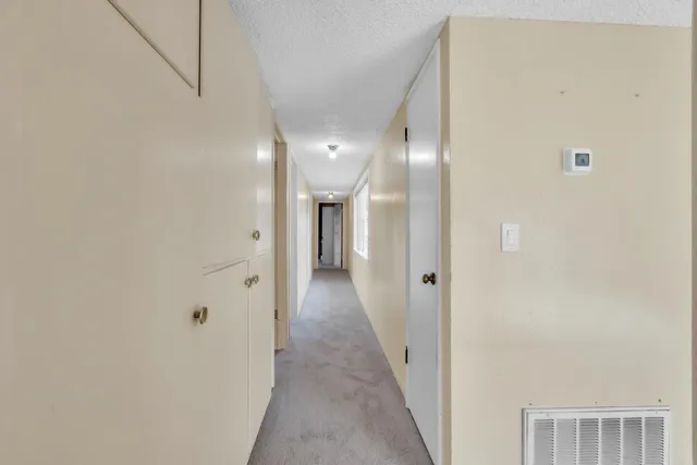 a bathroom with a sink a toilet a shower and a window