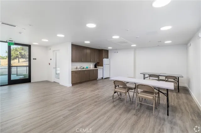 an open kitchen with a table and chairs in it