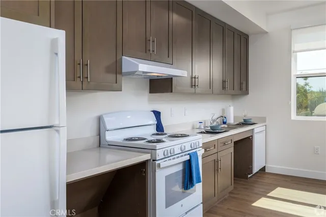 a kitchen with stainless steel appliances a stove a sink and a refrigerator