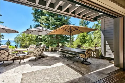 a view of backyard with outdoor seating and trees