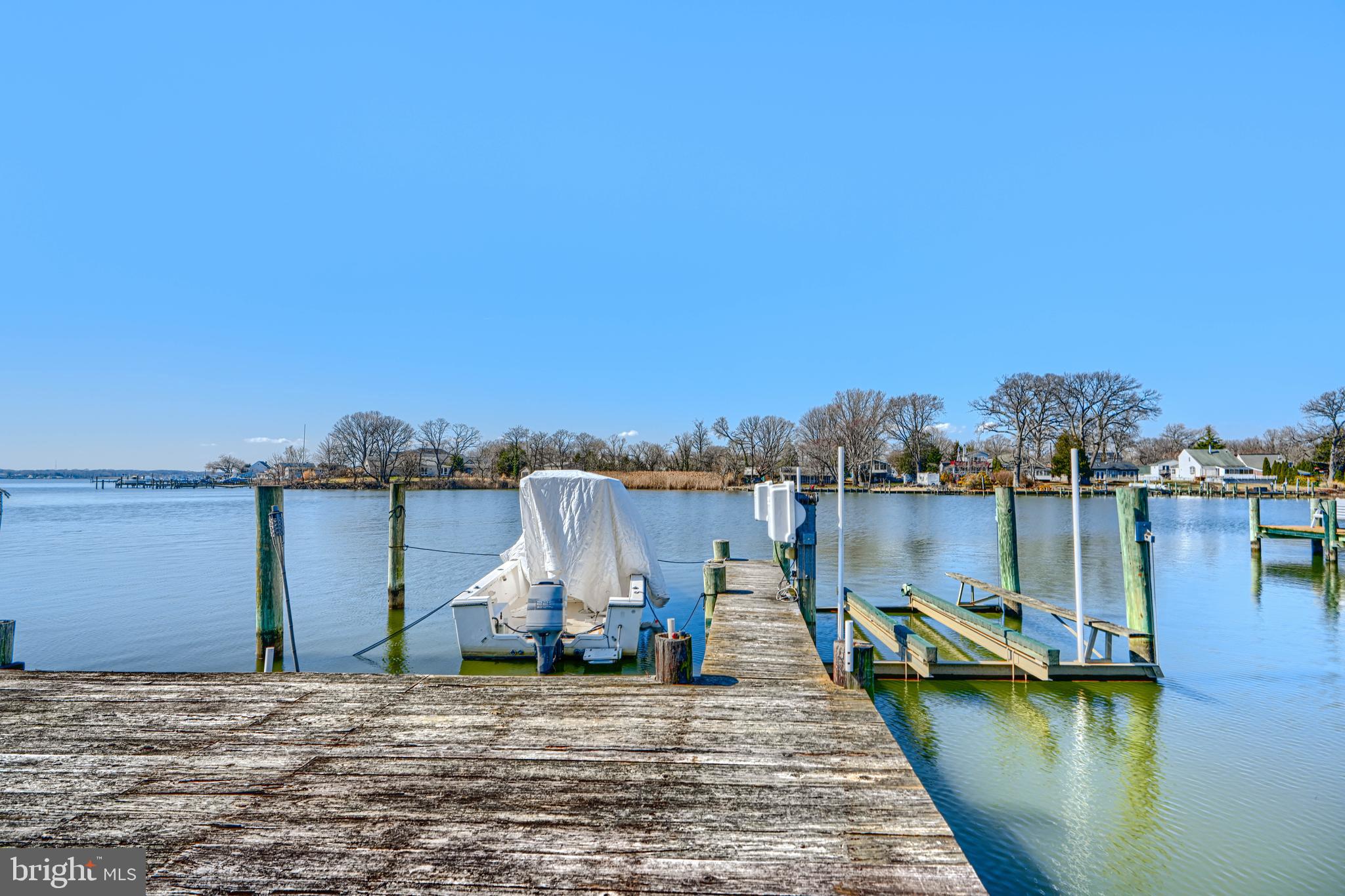 1510 Denton Road Essex, MD 21221 - Photo 31 of 39 a view of a lake with boats and trees in the background